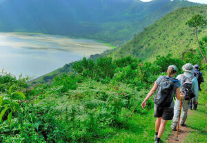 Empakai Crater hike in Tanzania with a lake inside the crater and Ol Doinyo Lengai in the distance